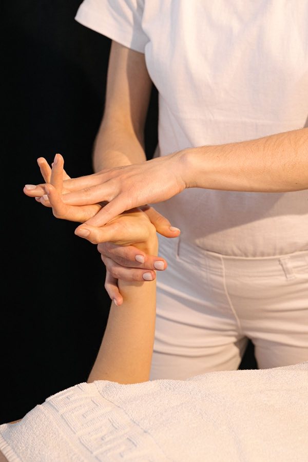 Massage des mains délicat sur une serviette en éponge blanche